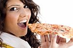 Young Woman Eating Pizza Stock Photo