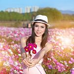 Young Woman Giving Bouquet Of Flowers Stock Photo