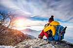 Young Woman Hiker Taking Photo With Smartphone On Mountains Peak In Winter Stock Photo