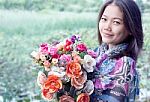 Young Woman Holding Artificial Flower Bouquet Stock Photo