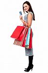 Young Woman Holding Shopping Bags And Credit Card Stock Photo