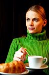 Young Woman Making Breakfast With A Cup Of Cappuccino And Croiss Stock Photo