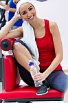 Young Woman Relaxing In The Gym After Making Exercise Stock Photo
