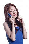 Young Woman Smiling And Texting On Her Mobile Phone Stock Photo
