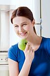 Young Woman Smiling Eating Apple Stock Photo