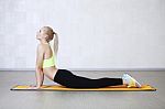 Young Woman Stretching Before Fitness Exercises On A Mat In A Gy Stock Photo