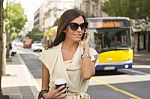 Young Woman Talking On The Phone On The Street Stock Photo