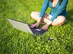 Young Woman Using Laptop And Mobile Phone Stock Photo