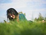 Young Woman Using Laptop In Park Stock Photo