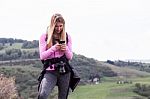 Young Woman Using Smart Phone In The Nature Stock Photo