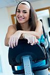 Young Woman With Elliptic Machine In The Gym Stock Photo