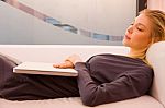 Young Woman With Laptop Sleeping Couch Stock Photo