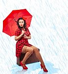 Young Woman With Umbrella Pinup Style Sitting In A Suitcase Stock Photo