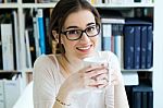 Young Worker Woman Having Coffee In Her Office Stock Photo