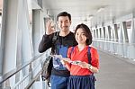 Younger Asian Traveling Man And Woman Standing With Toothy Smiling Face Sigh All Right By Okay Hand Sue For Modern People Backpacker Traveling Lifestyle Stock Photo